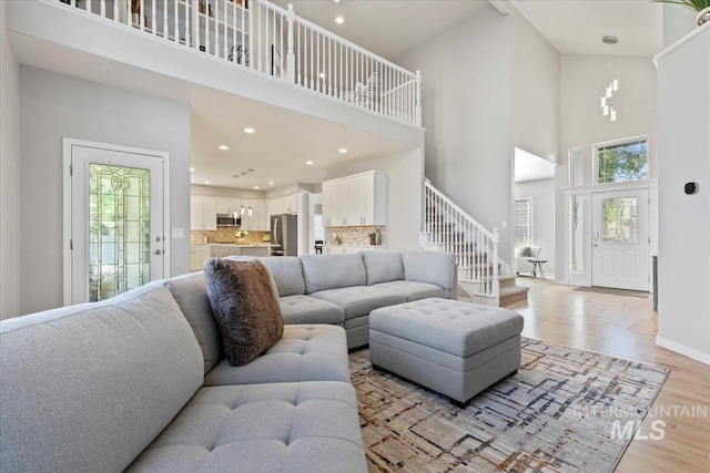 5915 N Lilybrook Pl, Boise, ID 83713 - living area with a towering ceiling, light wood-type flooring, stairs, recessed lighting, and baseboards