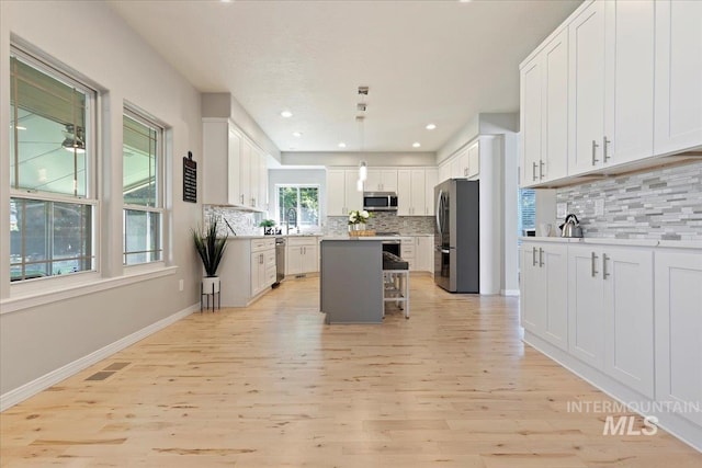 5915 N Lilybrook Pl, Boise, ID 83713 - kitchen with stainless steel appliances, backsplash, light wood-style flooring, and recessed lighting