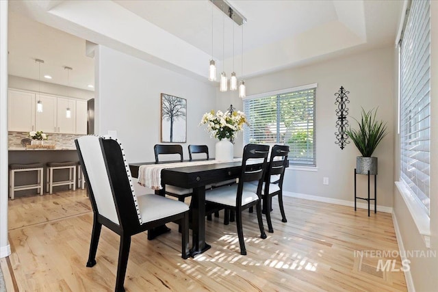 5915 N Lilybrook Pl, Boise, ID 83713 - dining area featuring light wood-type flooring, baseboards, and a chandelier