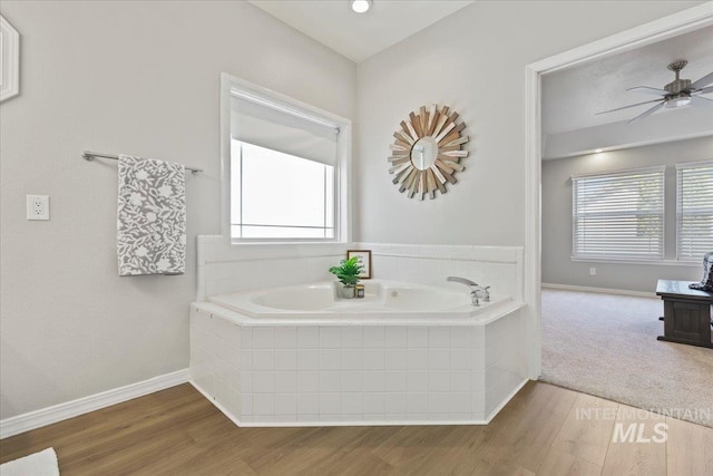 5915 N Lilybrook Pl, Boise, ID 83713 - bathroom with a garden tub, wood finished floors, and baseboards
