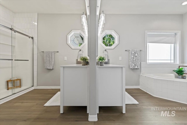 5915 N Lilybrook Pl, Boise, ID 83713 - bathroom with a bath, vanity, wood finished floors, and a stall shower