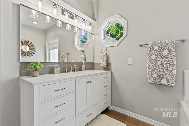 5915 N Lilybrook Pl, Boise, ID 83713 - bathroom featuring wood finished floors, decorative backsplash, vanity, and baseboards