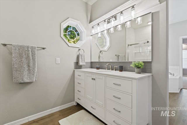 5915 N Lilybrook Pl, Boise, ID 83713 - bathroom featuring tasteful backsplash, vanity, wood finished floors, a shower, and baseboards