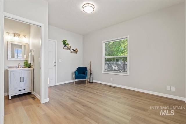 5915 N Lilybrook Pl, Boise, ID 83713 - unfurnished room featuring light wood finished floors, baseboards, and a textured ceiling