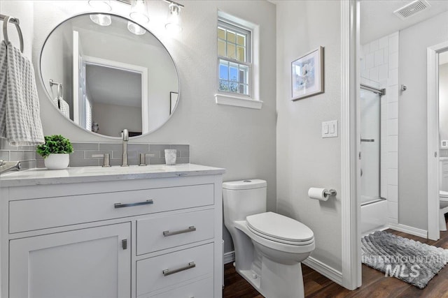 5915 N Lilybrook Pl, Boise, ID 83713 - bathroom with toilet, vanity, wood finished floors, and tasteful backsplash