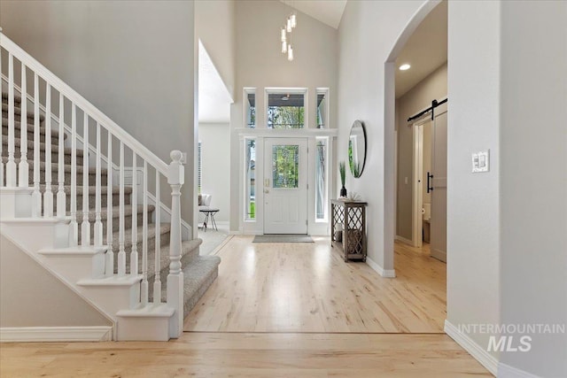 5915 N Lilybrook Pl, Boise, ID 83713 - entrance foyer with wood finished floors, a towering ceiling, stairs, arched walkways, and baseboards