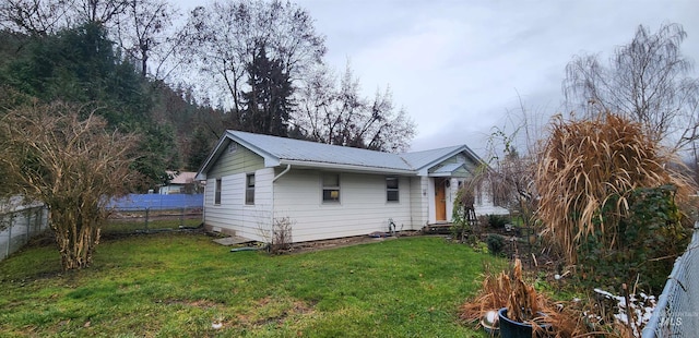 view of side of home with a yard