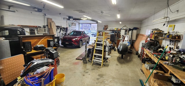 garage with a workshop area, ceiling fan, and a garage door opener