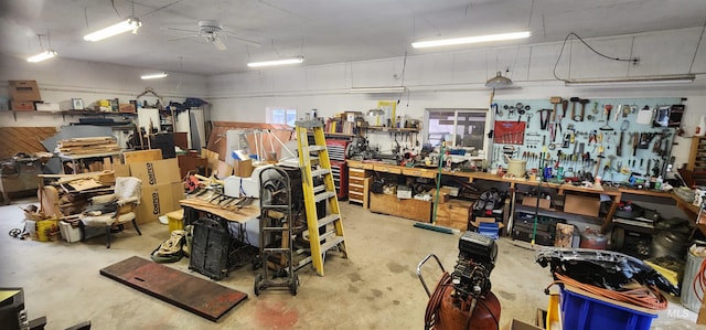 interior space featuring a workshop area, ceiling fan, and concrete floors