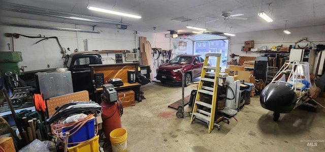 garage with a garage door opener and ceiling fan