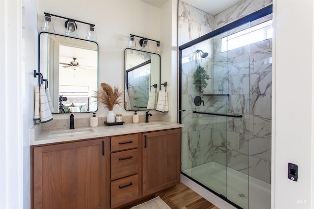 ensuite bathroom with a marble finish shower and a sink