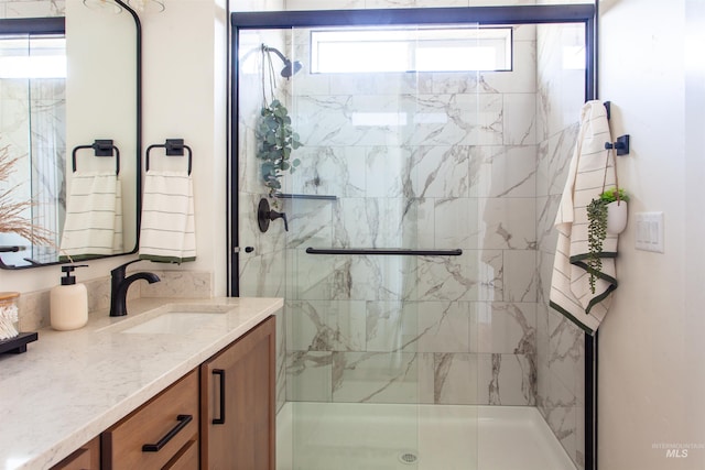 full bath with vanity and a stall shower