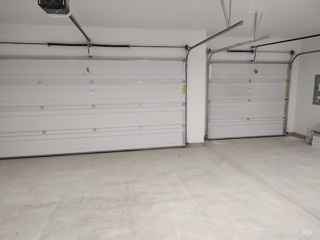 garage with a garage door opener and electric panel