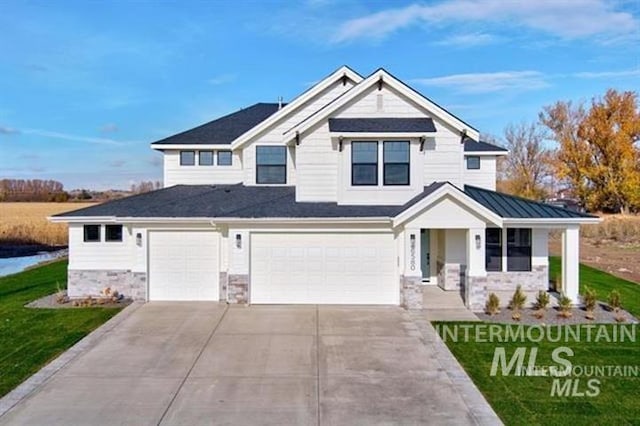 view of front facade with a porch, a garage, and a front lawn