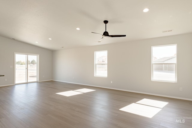 spare room with vaulted ceiling, ceiling fan, and light hardwood / wood-style floors