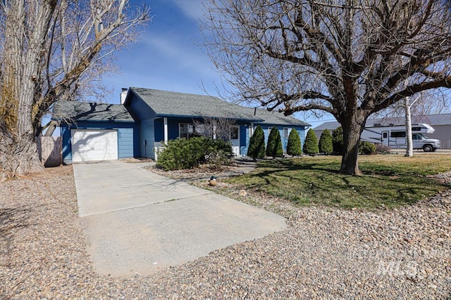 single story home with a front yard, an attached garage, and driveway