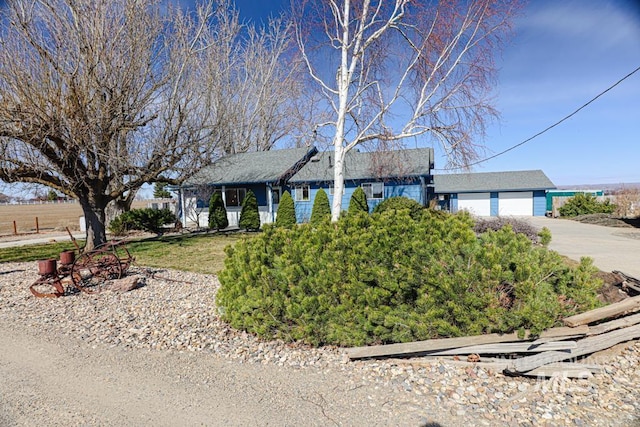 ranch-style home with concrete driveway