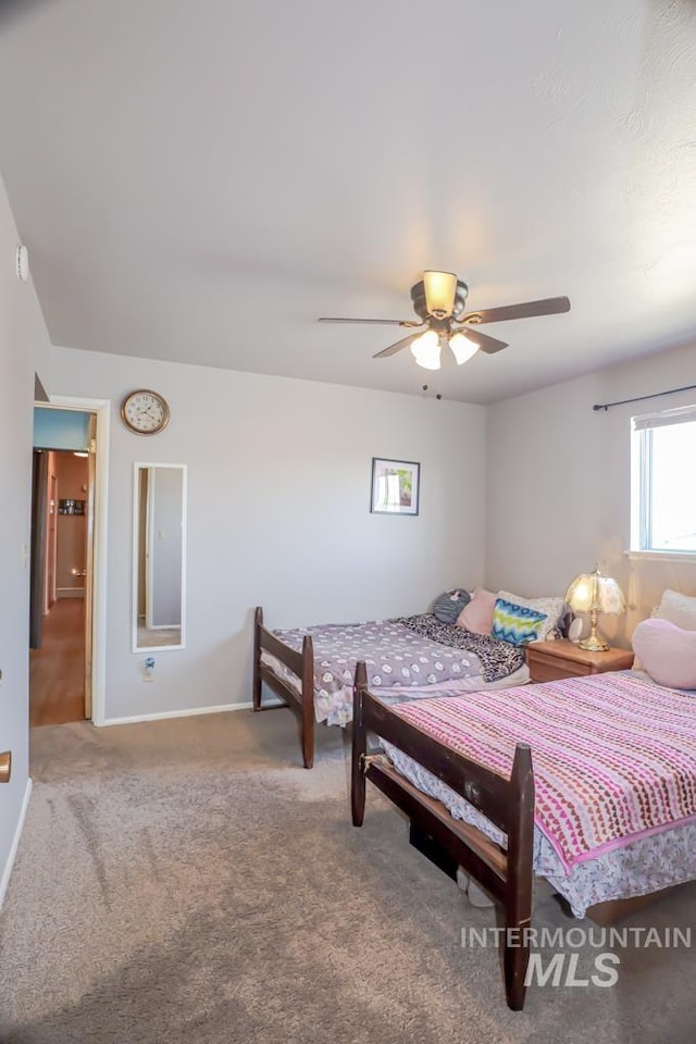 bedroom with baseboards, ceiling fan, and carpet flooring