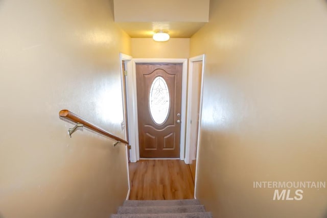 doorway with stairway and wood finished floors