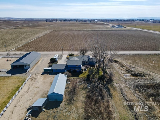 birds eye view of property with a rural view