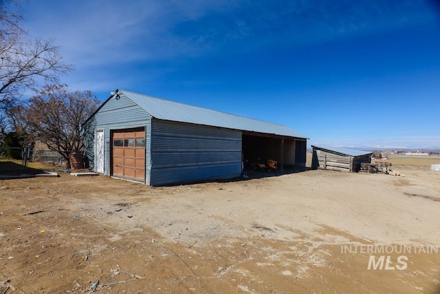 view of outdoor structure with an outbuilding and fence