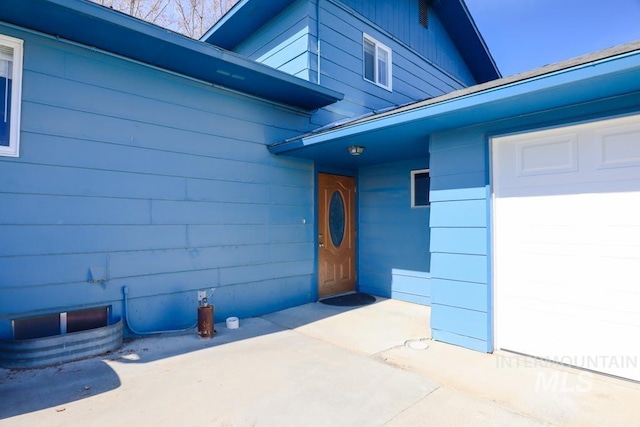 doorway to property featuring a garage