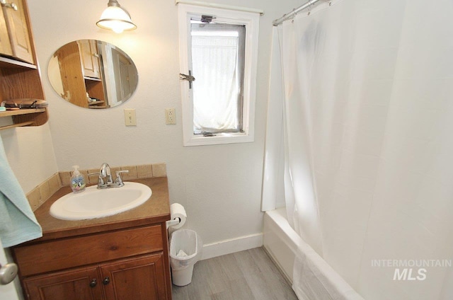 415 S Fern St, Nampa, ID 83686 - bathroom featuring baseboards, shower / tub combo with curtain, vanity, and wood finished floors