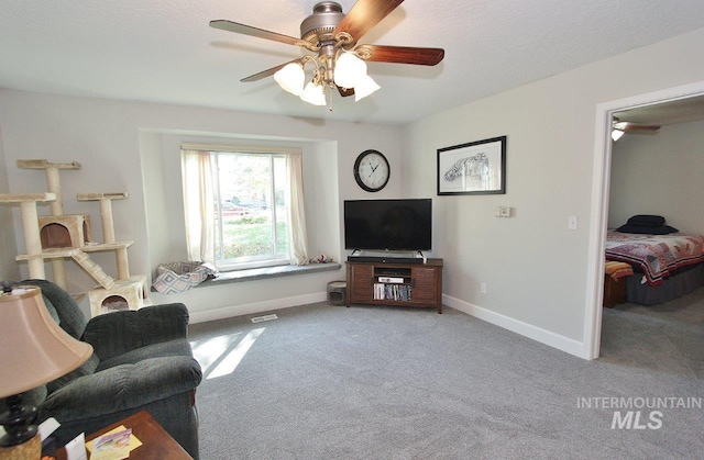415 S Fern St, Nampa, ID 83686 - living room featuring visible vents, carpet flooring, baseboards, and a ceiling fan