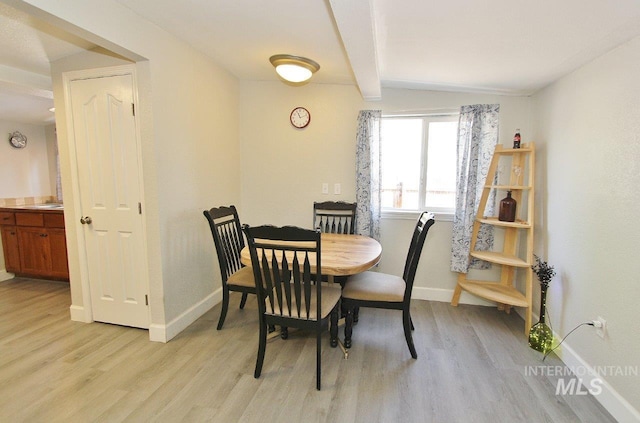 415 S Fern St, Nampa, ID 83686 - dining area with light wood finished floors, lofted ceiling with beams, and baseboards