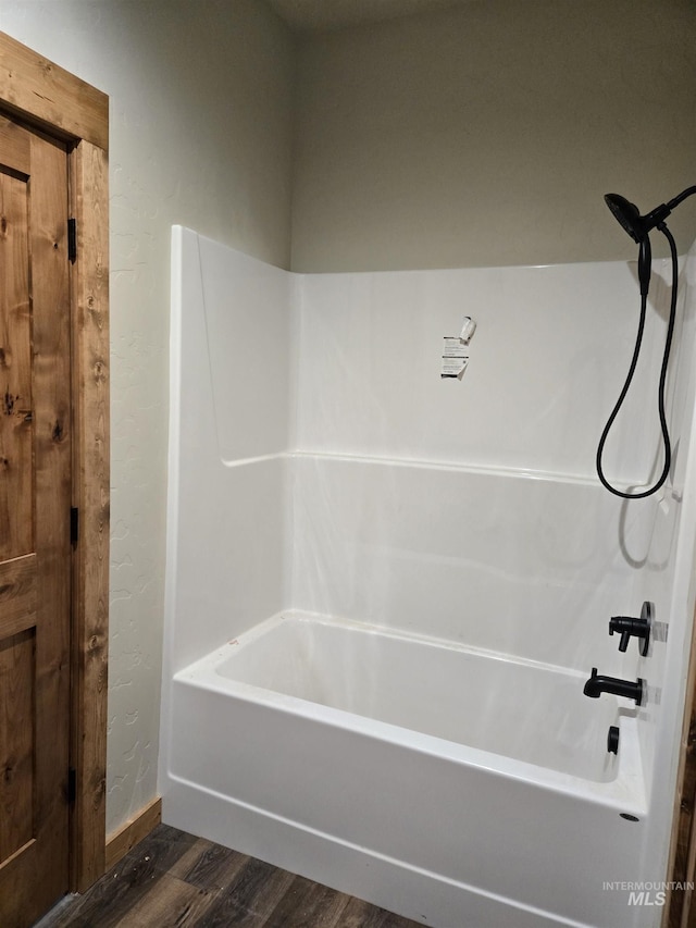 bathroom featuring shower / bathtub combination and wood-type flooring