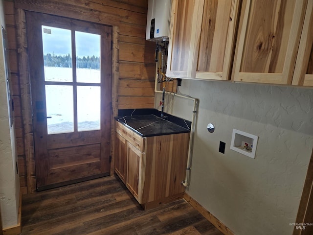 laundry area featuring dark wood-type flooring, a wealth of natural light, hookup for a washing machine, and cabinets