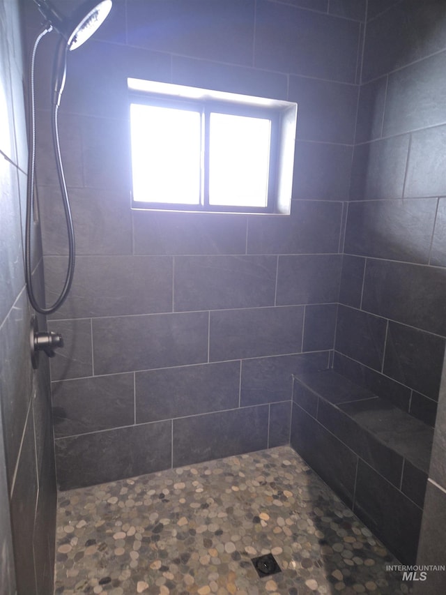 bathroom with tiled shower