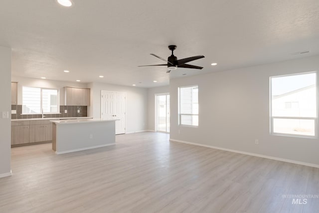 2059 N Thunderbolt St, Mountain Home, ID 83647 - unfurnished living room with light wood-style flooring, a ceiling fan, baseboards, and recessed lighting