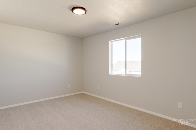 2059 N Thunderbolt St, Mountain Home, ID 83647 - carpeted empty room featuring baseboards and a textured ceiling