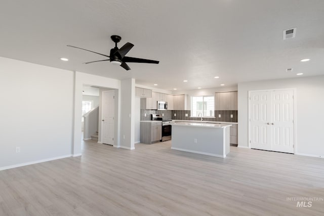 2059 N Thunderbolt St, Mountain Home, ID 83647 - kitchen with appliances with stainless steel finishes, open floor plan, a sink, light countertops, and recessed lighting