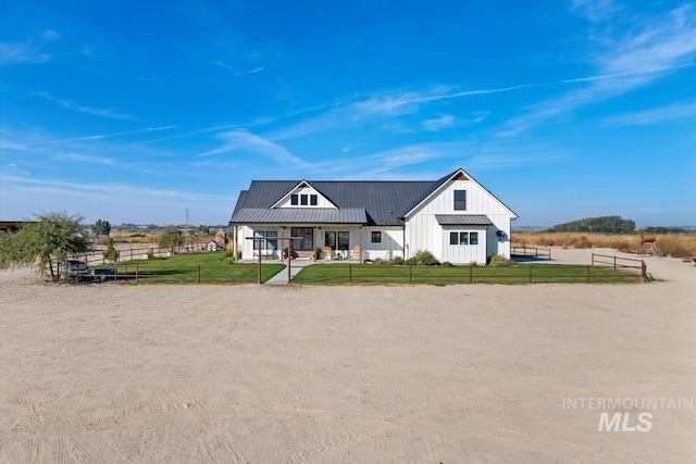 modern farmhouse featuring a front yard