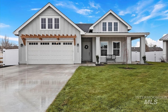 255 W Wrangler, Meridian, ID 83646 - view of front facade with fence, concrete driveway, a front yard, board and batten siding, and covered porch