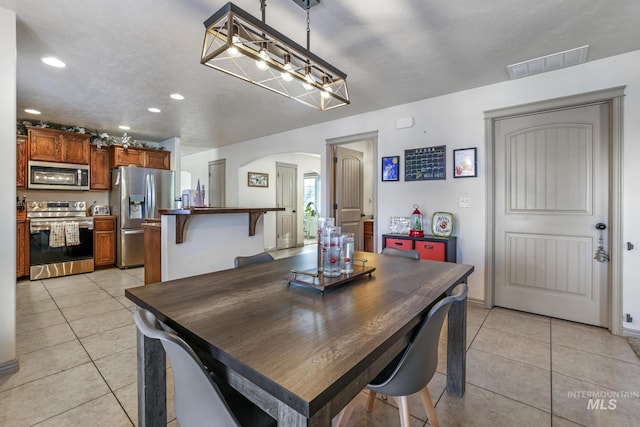 dining space featuring light tile patterned floors