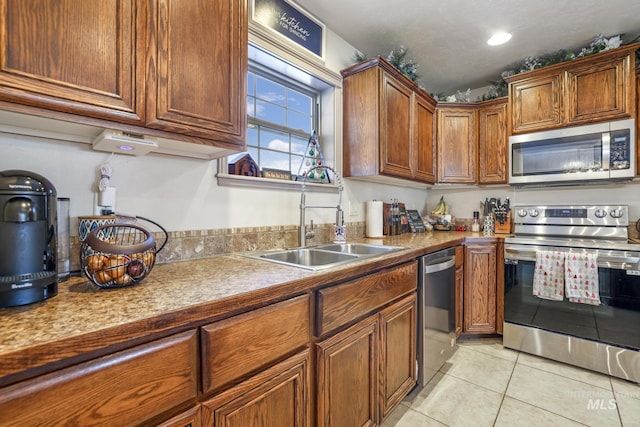 kitchen featuring sink, light tile patterned floors, and stainless steel appliances