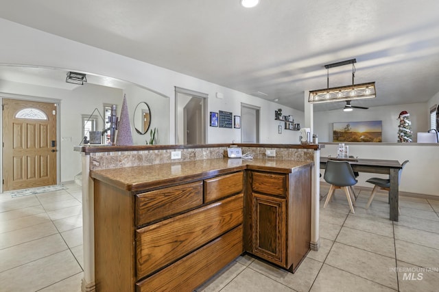 kitchen with ceiling fan, light tile patterned floors, and pendant lighting