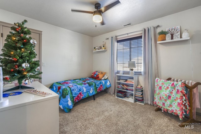 bedroom featuring ceiling fan and carpet