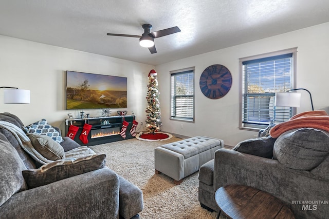 carpeted living room with plenty of natural light and ceiling fan