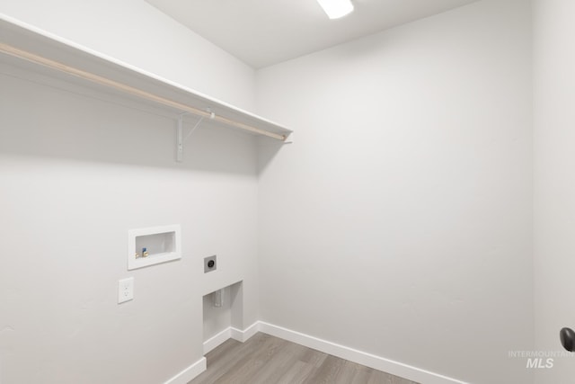 washroom with laundry area, washer hookup, wood finished floors, baseboards, and electric dryer hookup