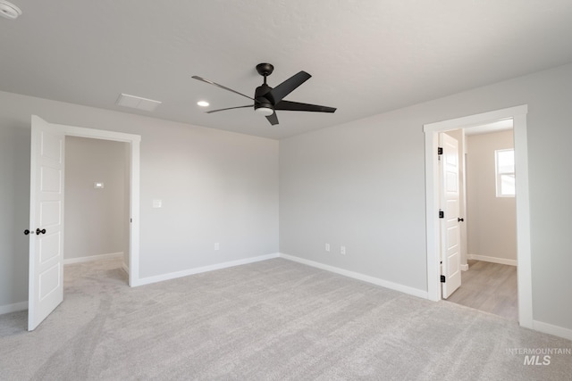 unfurnished bedroom with a ceiling fan, recessed lighting, light colored carpet, and baseboards