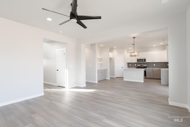 unfurnished living room featuring baseboards, recessed lighting, a ceiling fan, and light wood-style floors