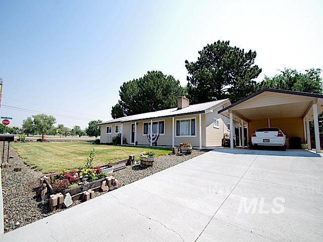 ranch-style house with a front lawn and a carport