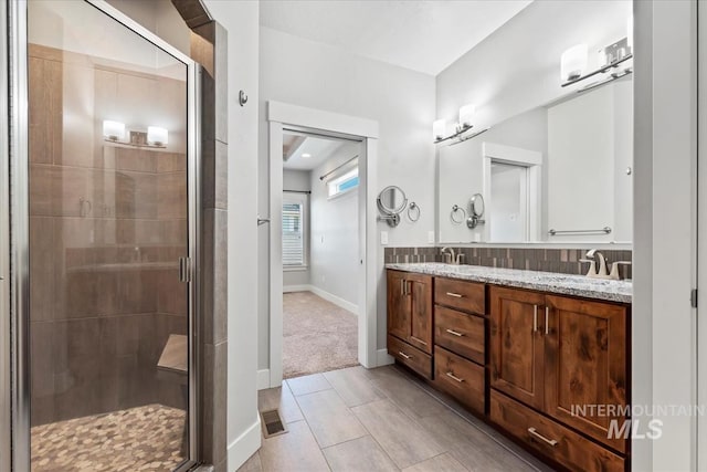15343 Moss Creek Way, Caldwell, ID 83607 - full bathroom with double vanity, a stall shower, and baseboards
