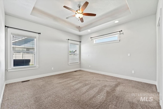 15343 Moss Creek Way, Caldwell, ID 83607 - carpeted spare room with a tray ceiling, baseboards, a ceiling fan, and recessed lighting