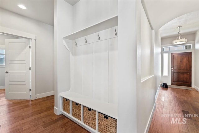 15343 Moss Creek Way, Caldwell, ID 83607 - mudroom featuring baseboards, wood finished floors, and arched walkways