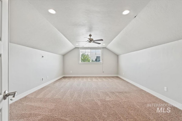 15343 Moss Creek Way, Caldwell, ID 83607 - bonus room featuring light colored carpet, a textured ceiling, lofted ceiling, baseboards, and ceiling fan